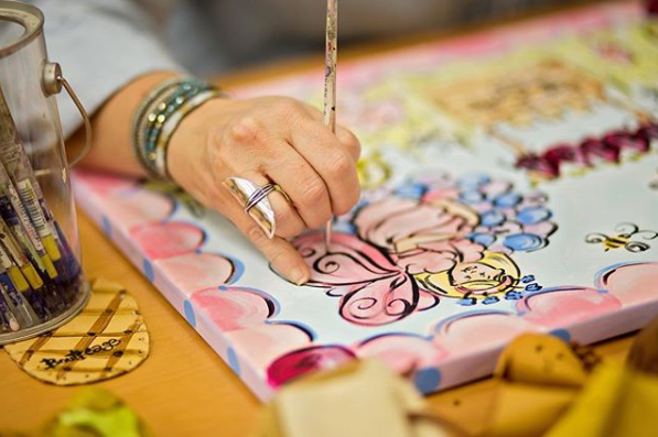 Artist painting at table